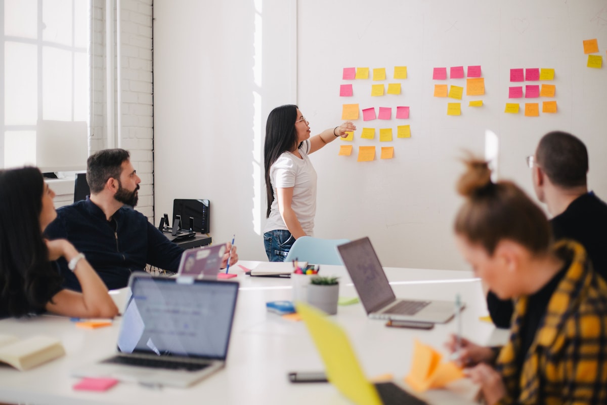 Healthcare consulting professionals collaborating around a table in a modern office setting